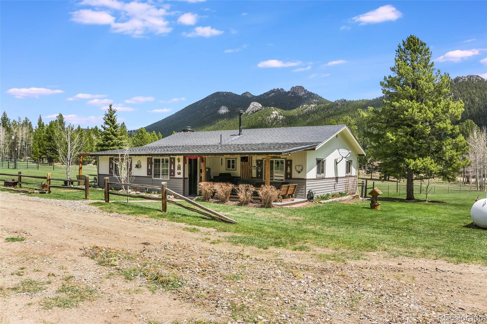 104 Mountain House Road Black Hawk, CO 80422 - Photo 1 of 32 a front view of a house with garden