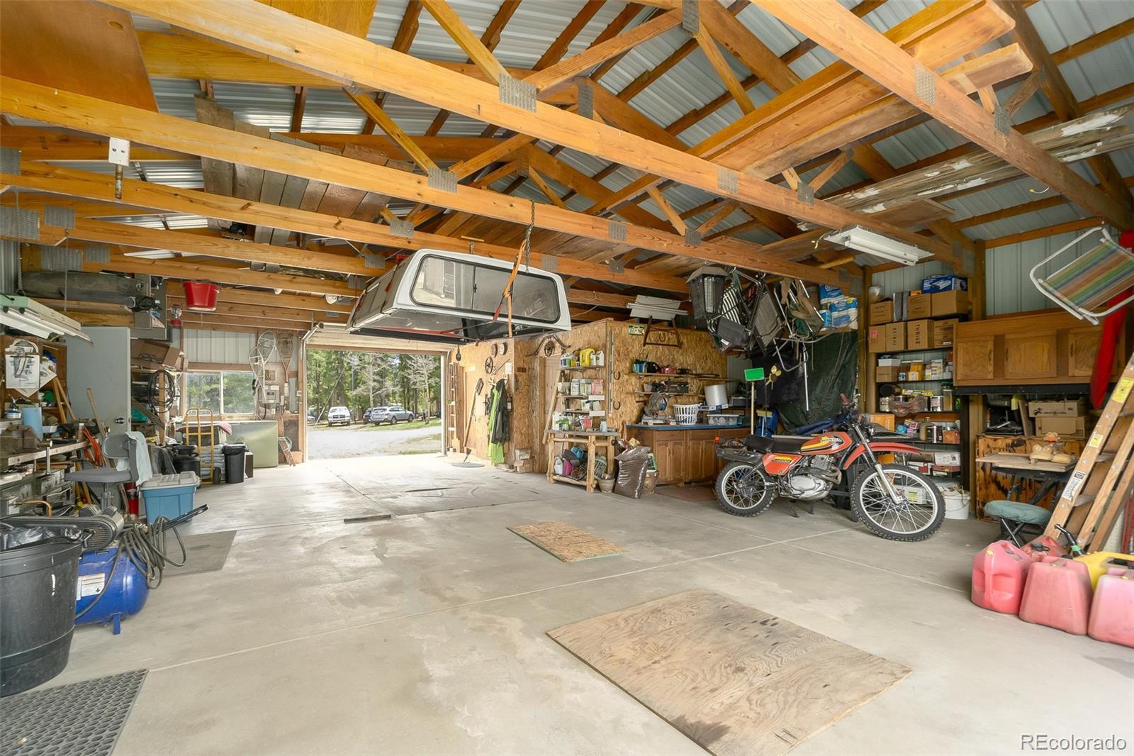 104 Mountain House Road Black Hawk, CO 80422 - Photo 23 of 32 a view of a garage with storage