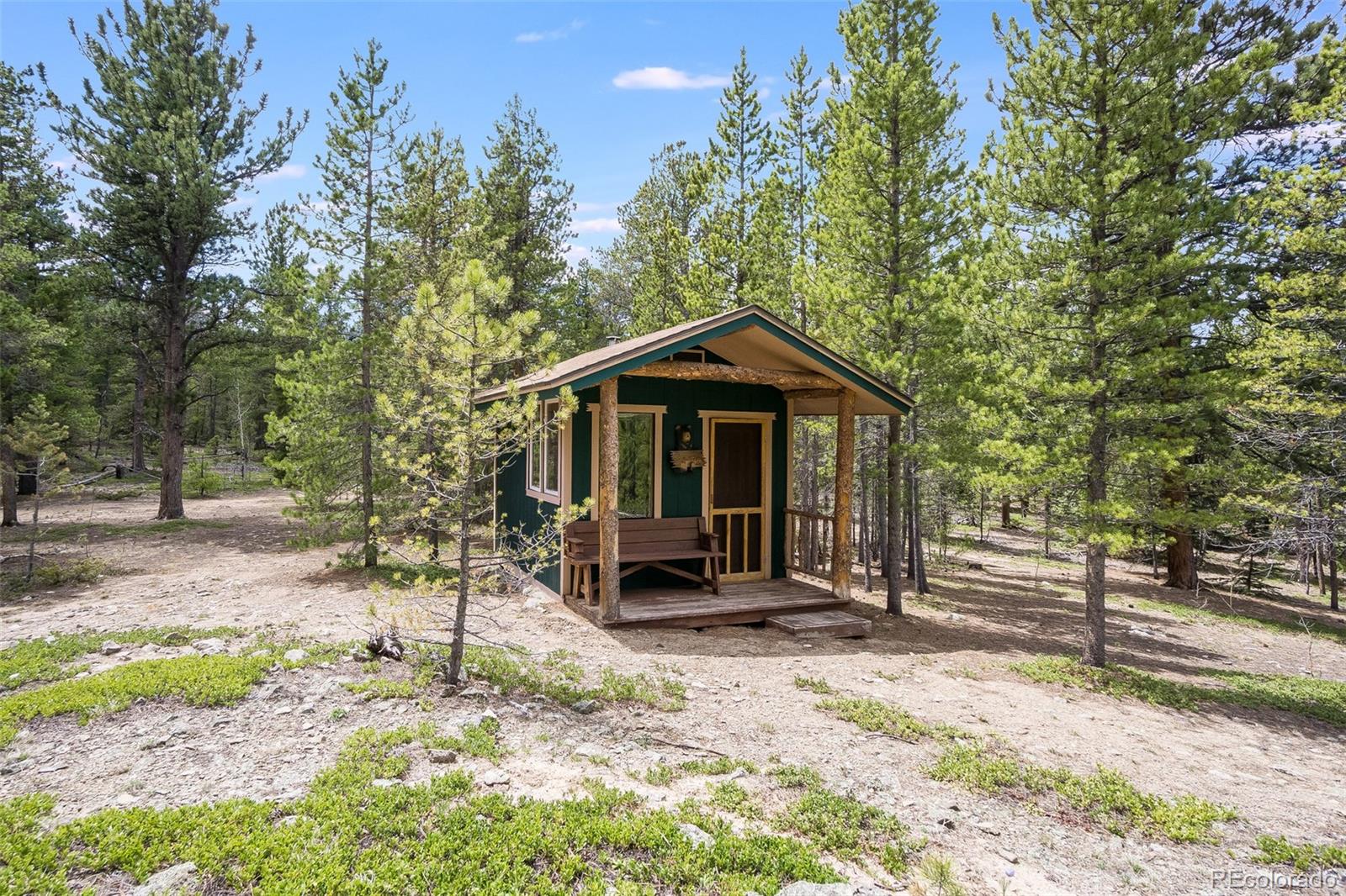 104 Mountain House Road Black Hawk, CO 80422 - Photo 24 of 32 a front view of a house with a garden