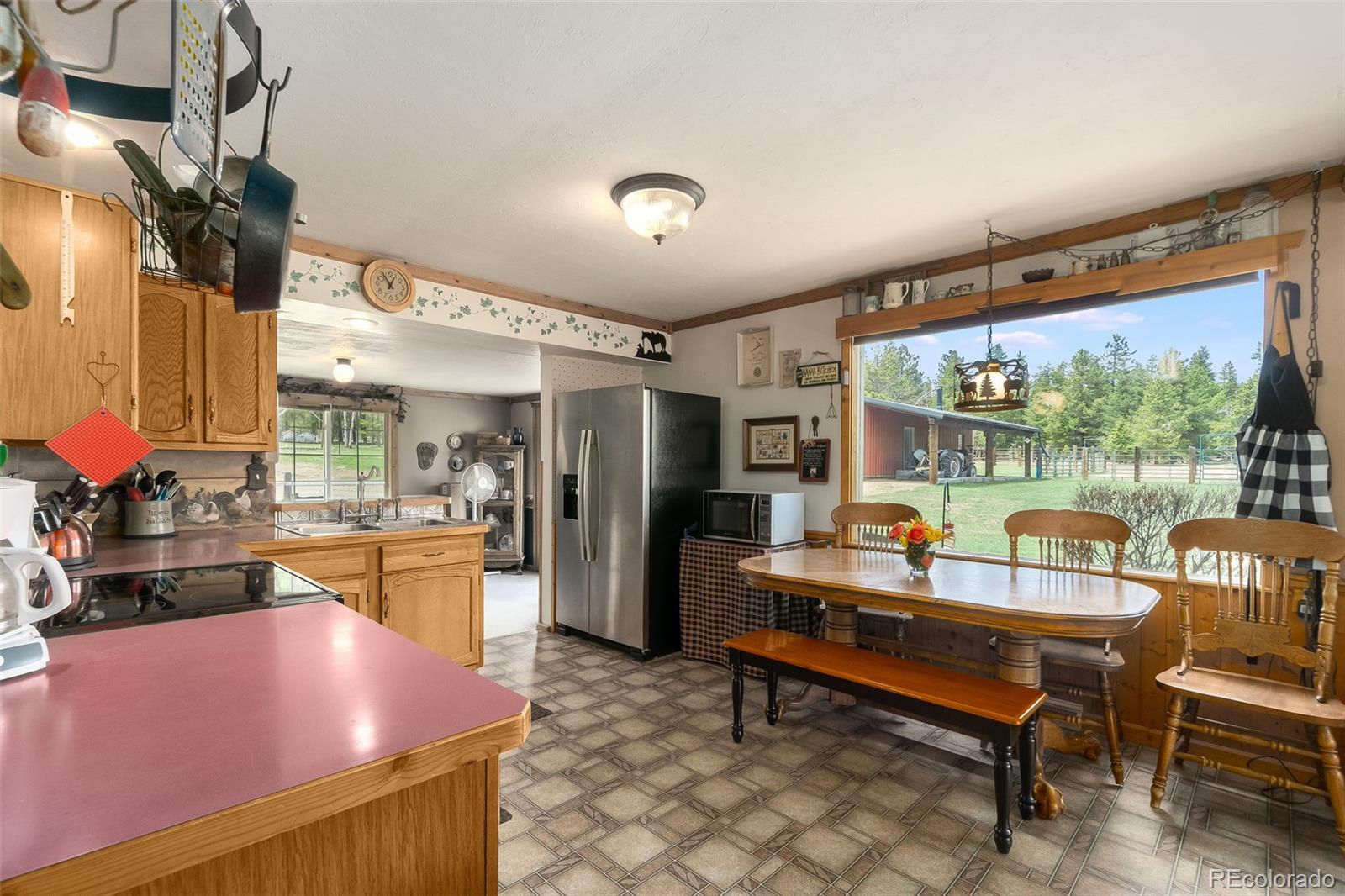 104 Mountain House Road Black Hawk, CO 80422 - Photo 9 of 32 a dining room with furniture and a floor to ceiling window