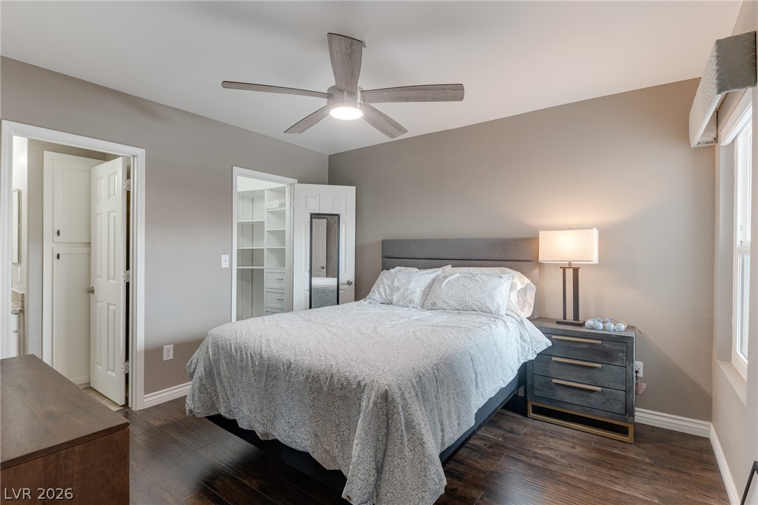 7255 West Sunset Road, Unit 2155 Las Vegas, NV 89113 - Photo 18 of 21 Bedroom featuring a spacious closet, dark wood-style floors, and a ceiling fan