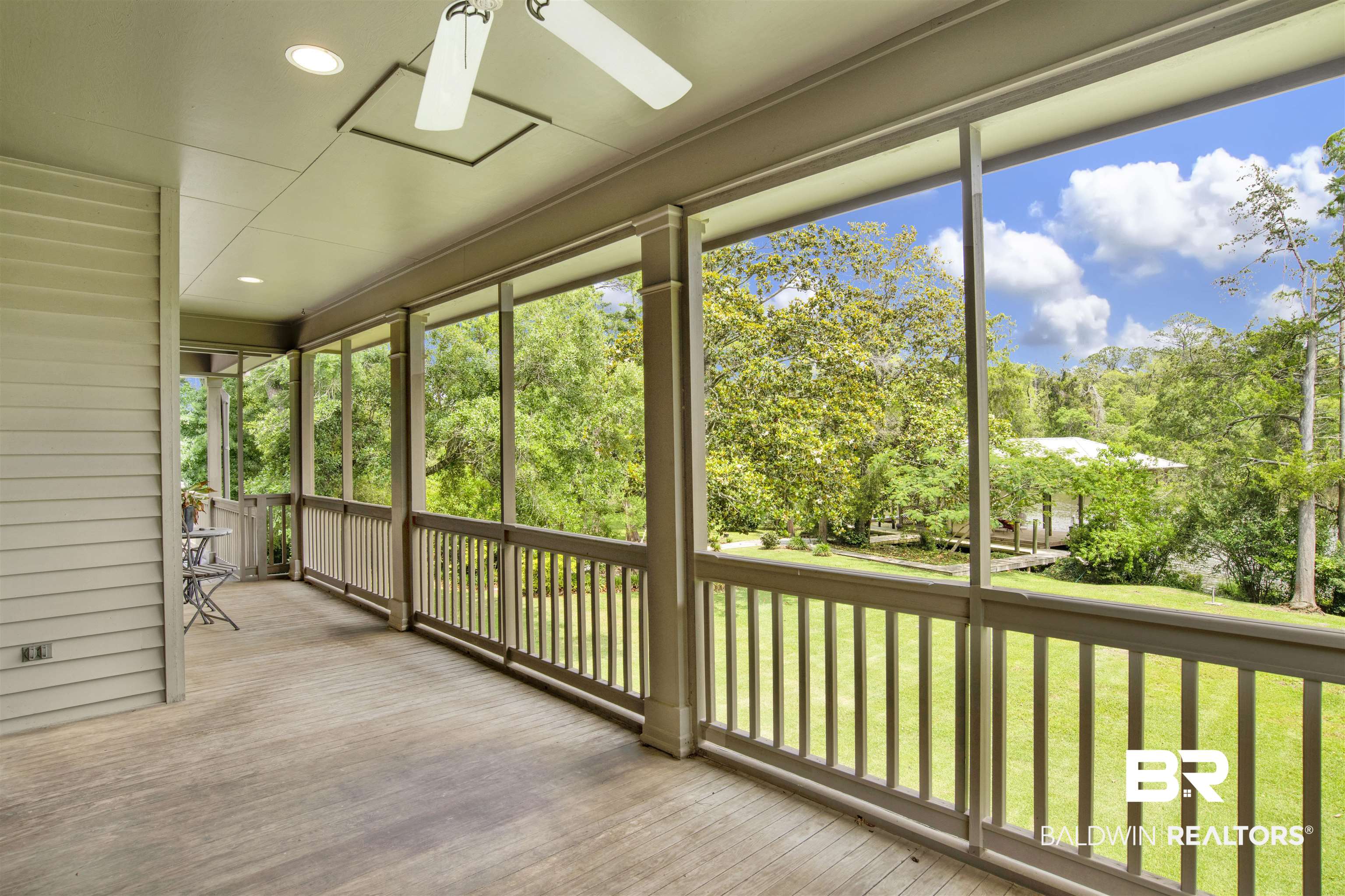 16864 Ferry Rd Circle Fairhope, AL 36532 - Photo 7 of 68 Unfurnished sunroom featuring a ceiling fan, view of scattered trees, and healthy amount of natural light