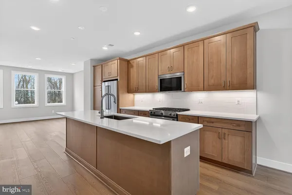 a kitchen with a sink stove and cabinets