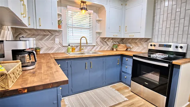a kitchen with kitchen island stainless steel appliances a sink a counter top space