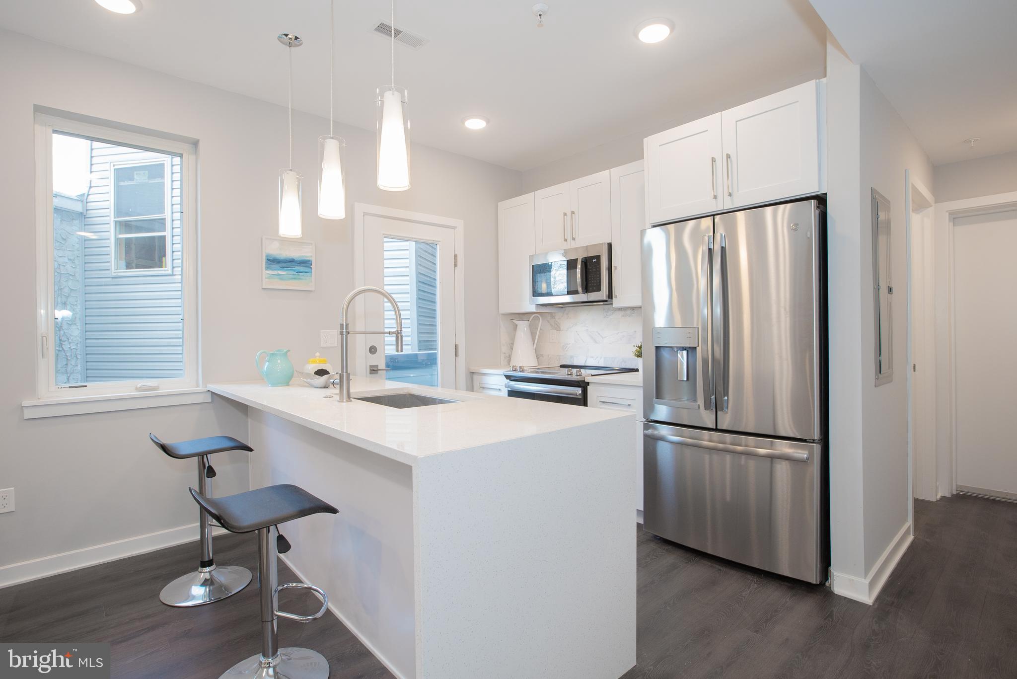 1534 Ridge Avenue, Unit 202 Philadelphia, PA 19130 - Photo 11 of 20 a kitchen with kitchen island a appliances a sink and a refrigerator