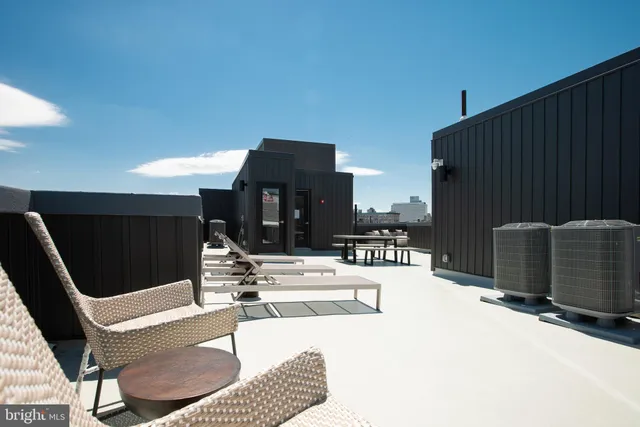 a view of a patio with table and chairs a barbeque