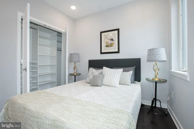 a bedroom with a bed and a lamp on table