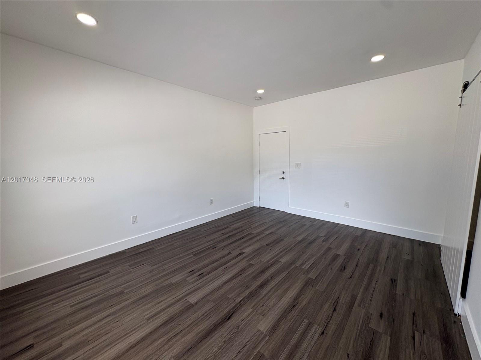3237 Southwest 4th Street, Unit 6 Miami, FL 33135 - Photo 3 of 10 a view of room with wooden floor and fan
