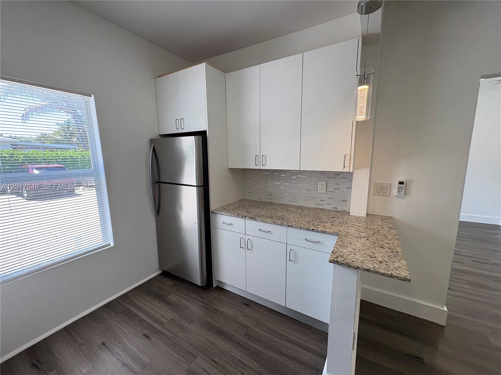 3237 Southwest 4th Street, Unit 6 Miami, FL 33135 - Photo 6 of 10 a kitchen with stainless steel appliances granite countertop a refrigerator and a stove