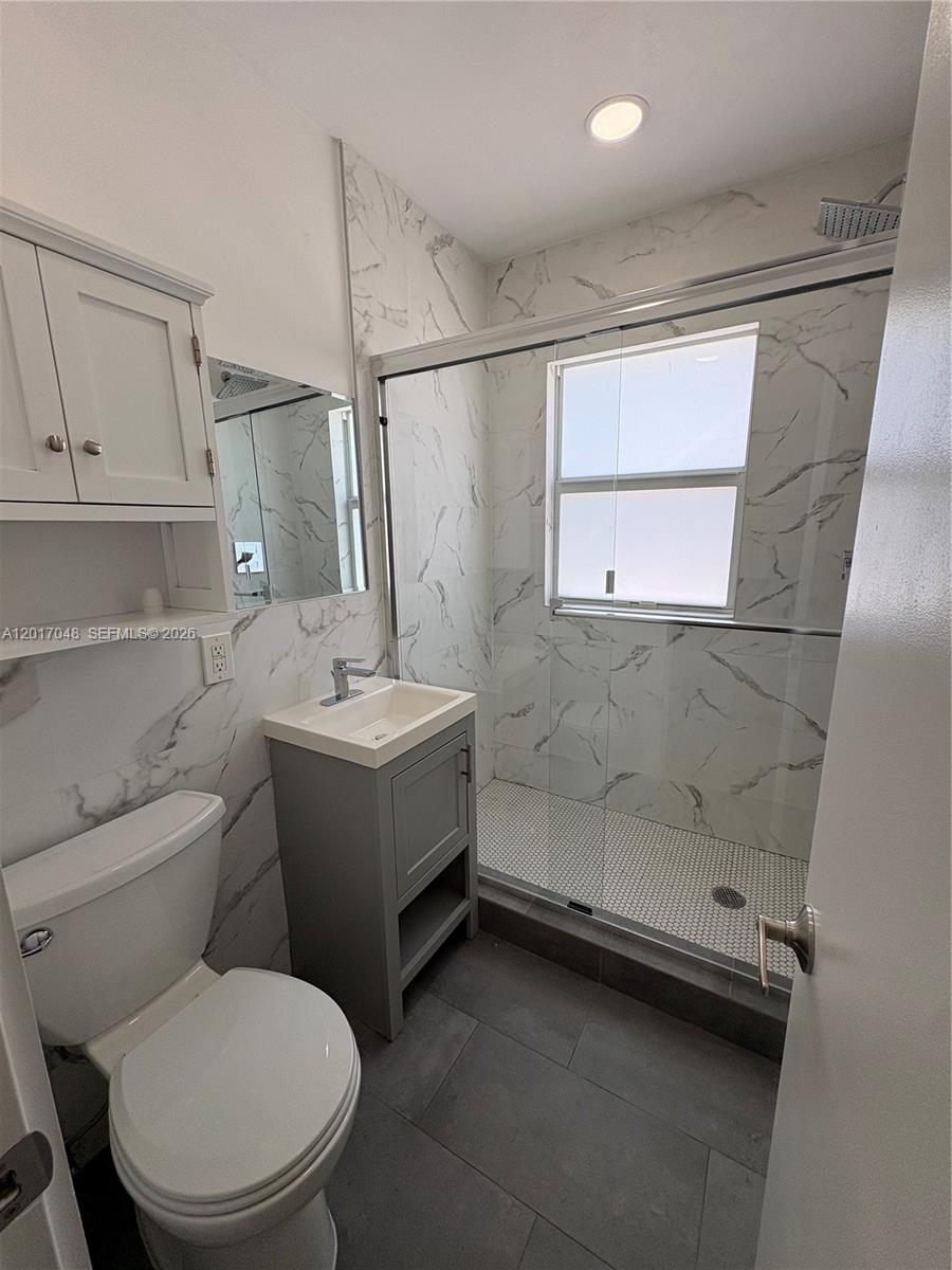 3237 Southwest 4th Street, Unit 6 Miami, FL 33135 - Photo 8 of 10 a bathroom with a sink a toilet and shower