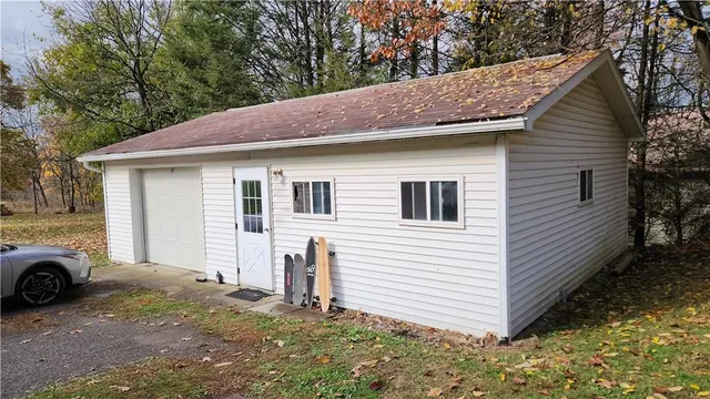 a view of a house with a yard and garage