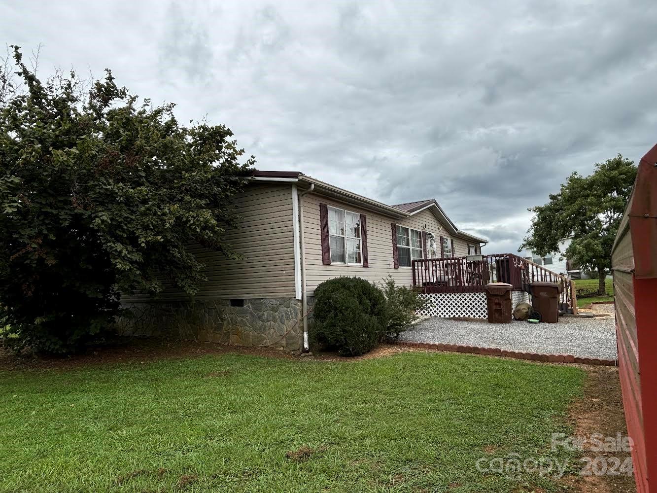 4812 Rifle Range Road Conover, NC 28613 - Photo 7 of 7 a backyard of a house with table and chairs plants and large trees