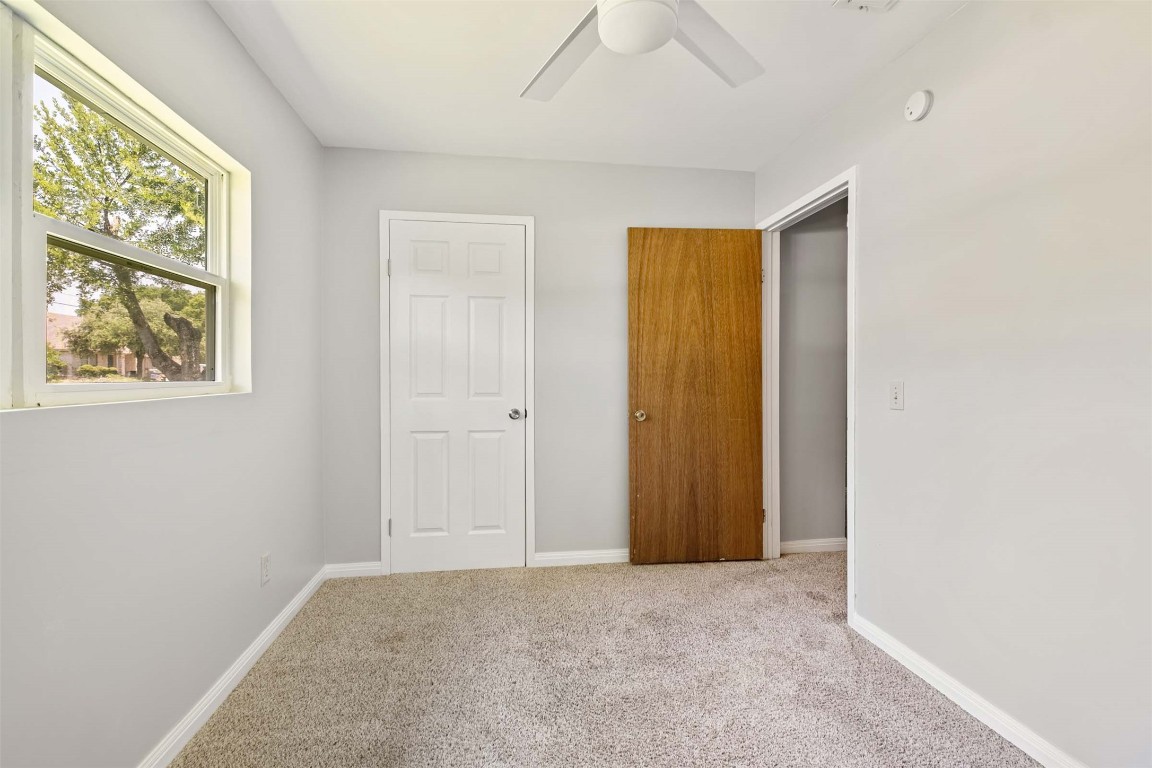 2502 Cypress Lane Cedar Park, TX 78613 - Photo 17 of 25 a view of an empty room with window and hallway
