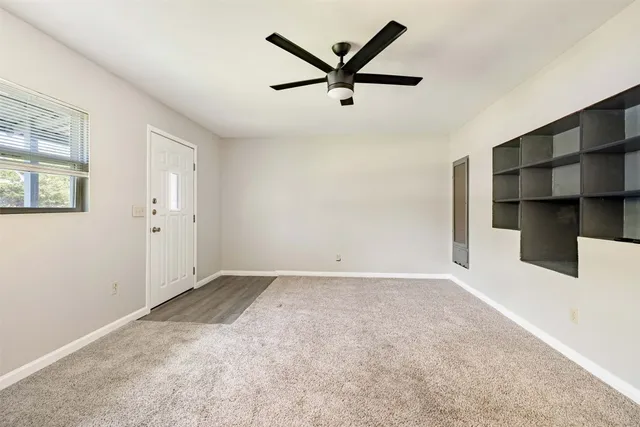 an empty room with closet and windows