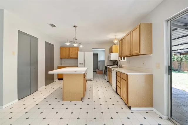 a kitchen with a sink stove and cabinets