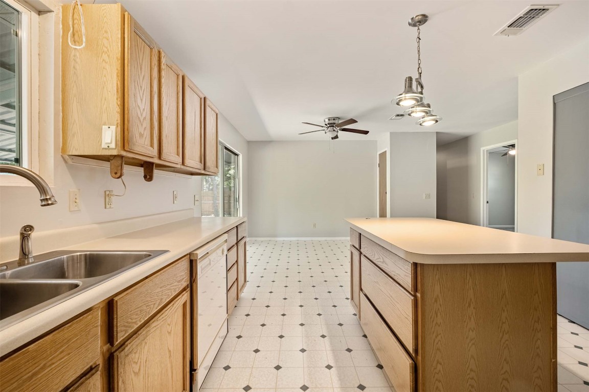 2502 Cypress Lane Cedar Park, TX 78613 - Photo 9 of 25 a kitchen with a sink a stove and a window