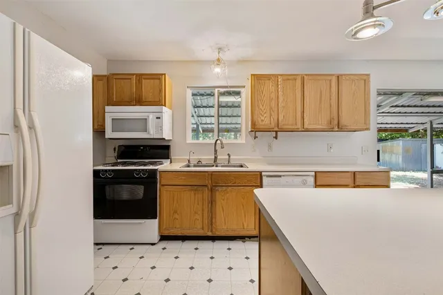 a kitchen with stainless steel appliances a sink stove and refrigerator
