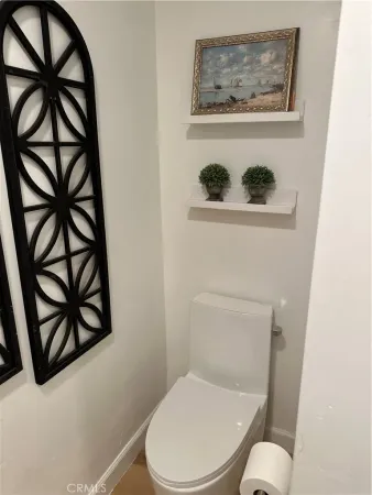 a white toilet sitting next to a window