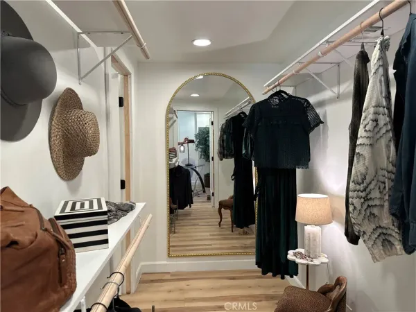 a view of walk in closet with wooden floor