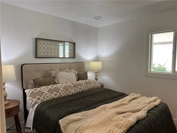 a bedroom with a bed and a window