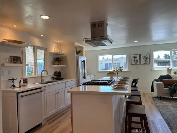 a kitchen with counter top space a sink and appliances