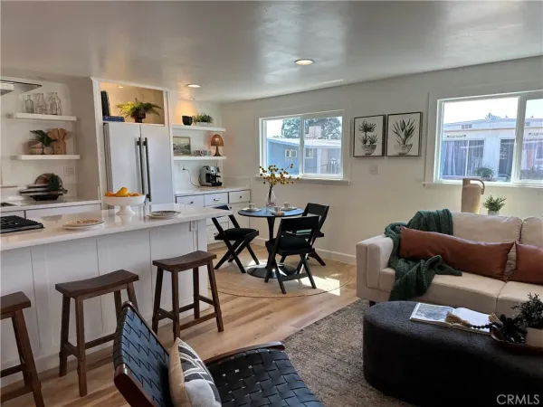 a view of a dining room with furniture and a kitchen