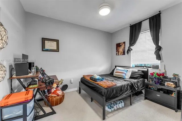 a bedroom with furniture and a window