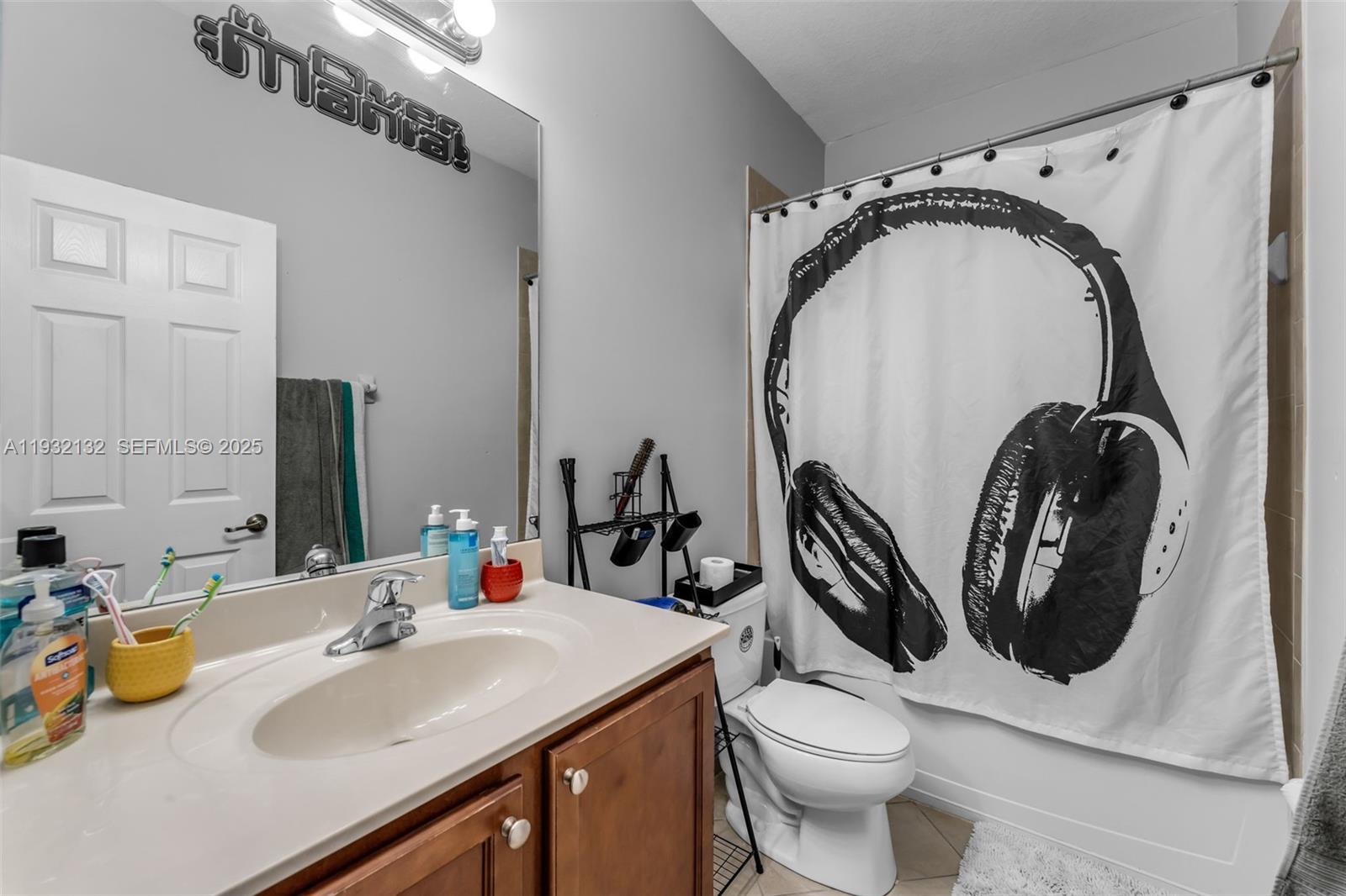 22813 Southwest 88th Path Cutler Bay, FL 33190 - Photo 13 of 24 a bathroom with a toilet sink and mirror