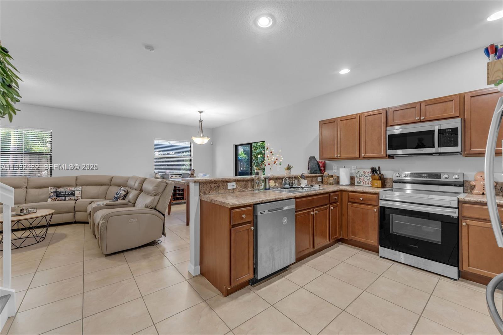22813 Southwest 88th Path Cutler Bay, FL 33190 - Photo 2 of 24 a kitchen with a stove a sink and a microwave