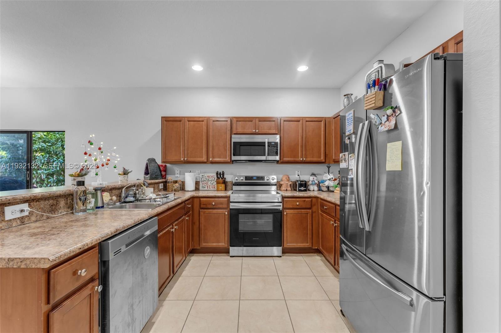 22813 Southwest 88th Path Cutler Bay, FL 33190 - Photo 4 of 24 a kitchen with stainless steel appliances granite countertop a refrigerator and a stove top oven