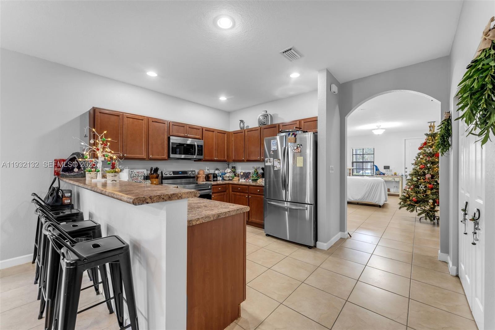 22813 Southwest 88th Path Cutler Bay, FL 33190 - Photo 5 of 24 a kitchen with stainless steel appliances granite countertop a refrigerator and a stove top oven