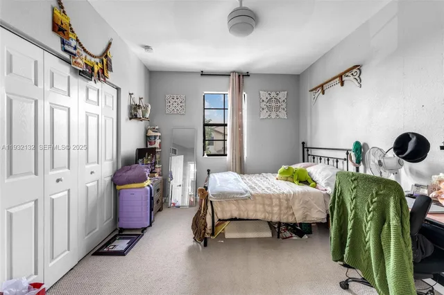 a bedroom with bed and window