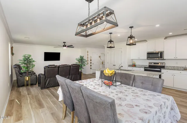 a kitchen with a sink stainless steel appliances and white cabinets