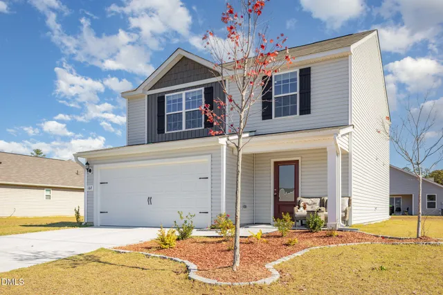 a front view of a house with a yard