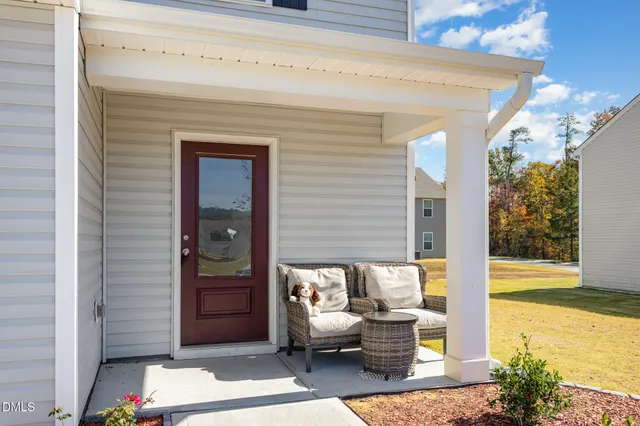 a view of a patio with table and chairs and potted plants