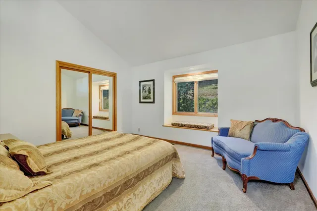 a living room with furniture and painting on the wall