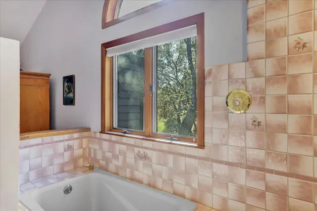 a view of a house with backyard outdoor seating area and garden