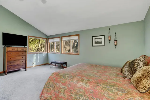 a living room with furniture a window and gym equipment