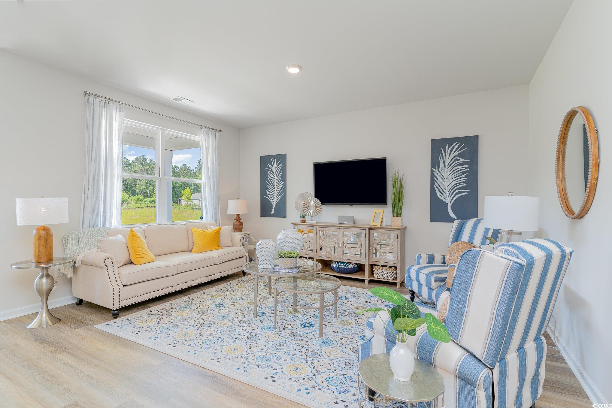 7366 Meadow Walk Loop Loris, SC 29569 - Photo 5 of 20 Living area featuring wood finished floors and baseboards