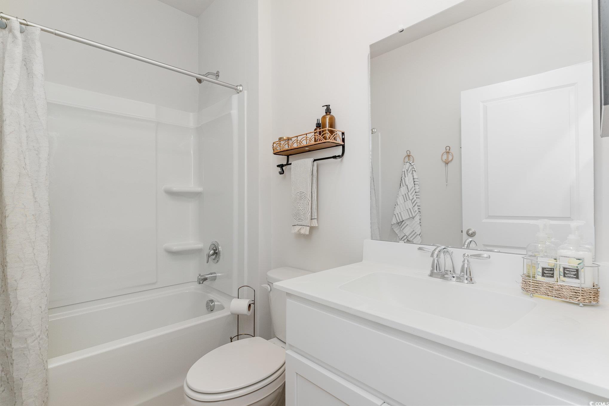 7366 Meadow Walk Loop Loris, SC 29569 - Photo 6 of 20 Full bathroom featuring shower / bath combo with shower curtain and vanity