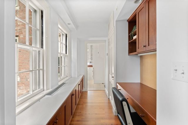 a workspace room with furniture and window