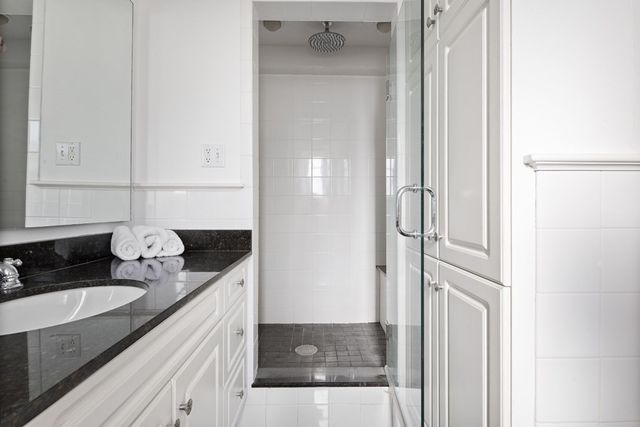 a spacious bedroom with a bed and wooden floor