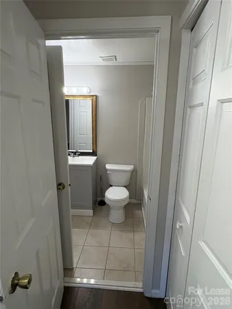 a bathroom with a sink a toilet a vanity and mirror
