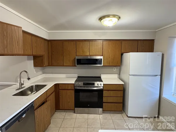 a kitchen with a refrigerator sink and cabinets