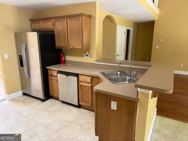 a kitchen with stainless steel appliances a sink and a refrigerator