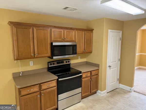 a kitchen with a stove and a microwave
