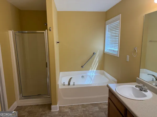 a bathroom with a tub and a sink