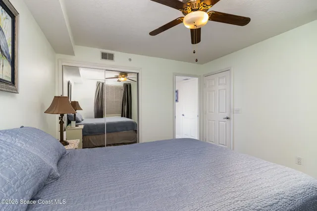 a bedroom with bed and a chandelier