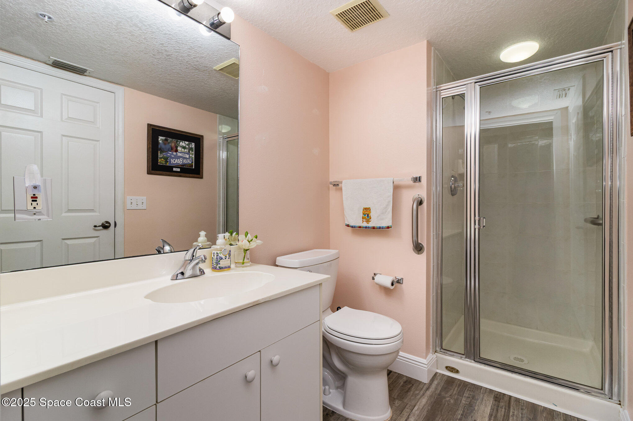 102 Riverside Drive, Unit 203 Cocoa, FL 32922 - Photo 14 of 26 a bathroom with a sink a toilet and shower