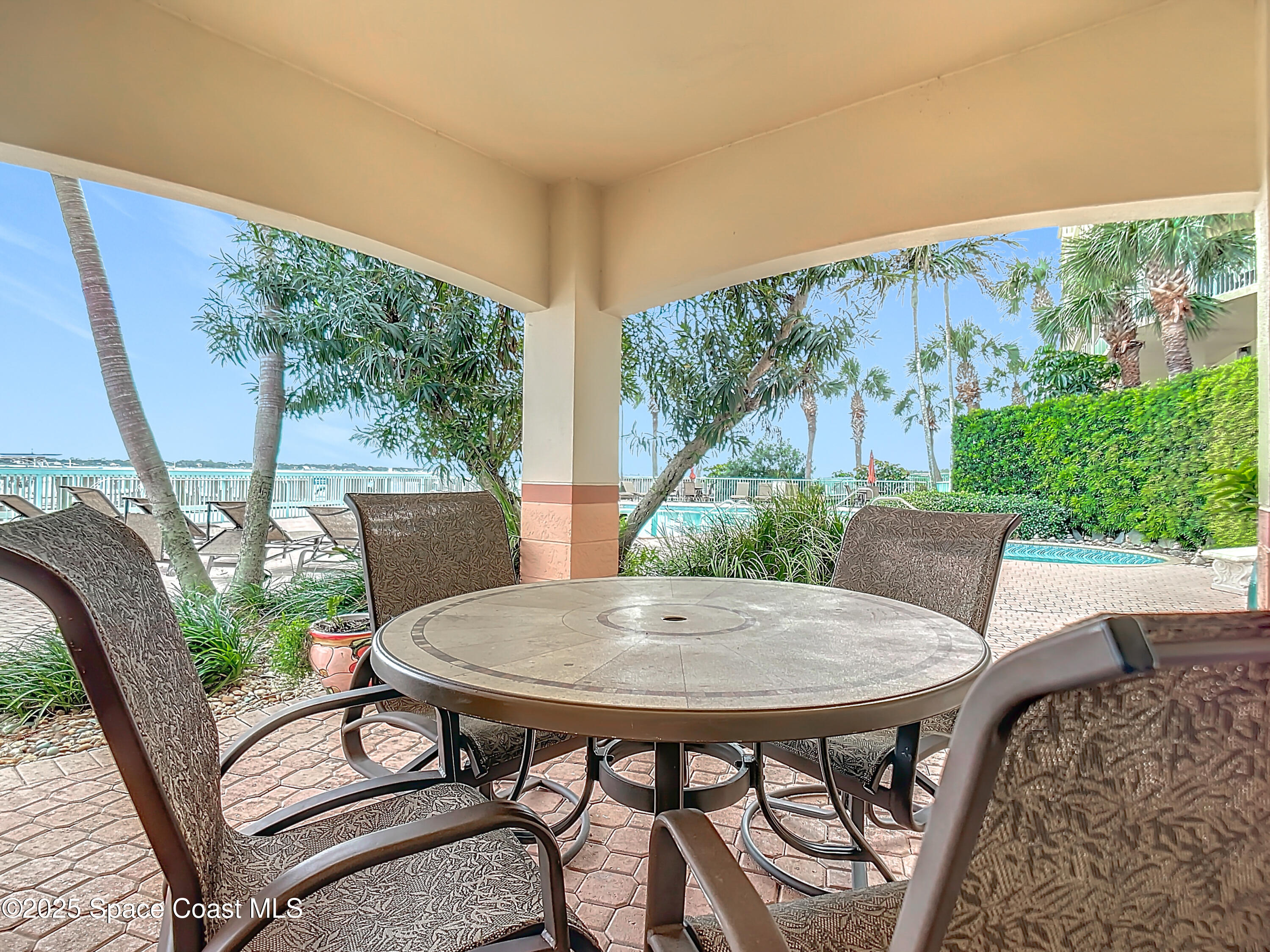 102 Riverside Drive, Unit 203 Cocoa, FL 32922 - Photo 18 of 26 a view of a patio with a table chairs and a table